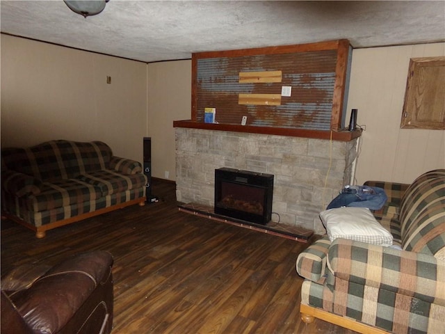 living room with a fireplace, dark hardwood / wood-style floors, and a textured ceiling