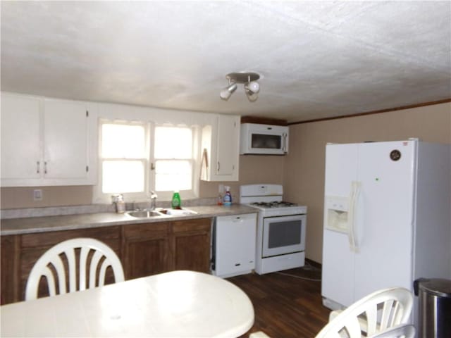 kitchen with white cabinetry, white appliances, dark hardwood / wood-style floors, and sink