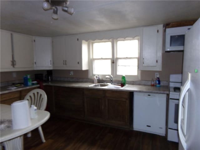 kitchen with white cabinetry, sink, dark wood-type flooring, and white appliances