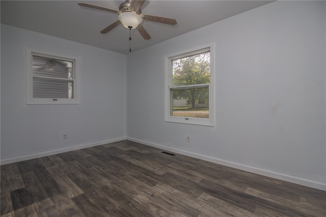 spare room featuring ceiling fan and dark wood-type flooring