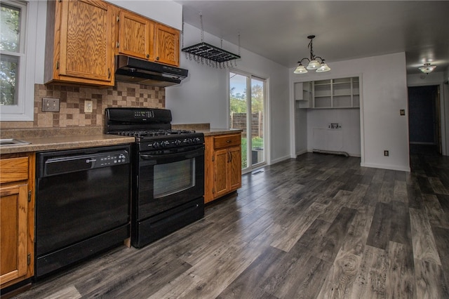 kitchen featuring an inviting chandelier, dark hardwood / wood-style floors, backsplash, decorative light fixtures, and black appliances