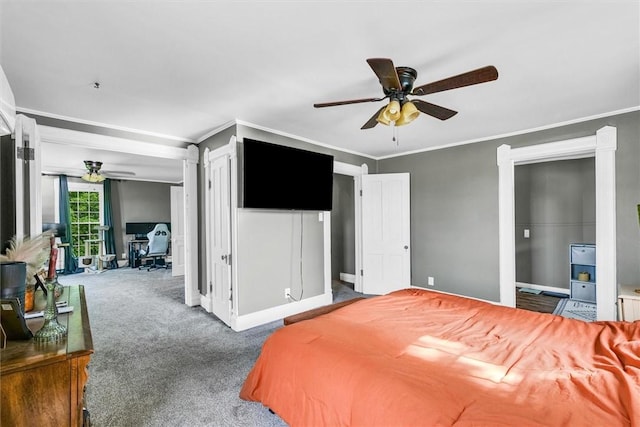 carpeted bedroom with crown molding, baseboards, and ceiling fan