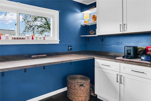 kitchen with white cabinetry and open shelves
