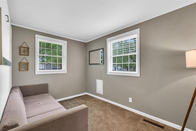sitting room featuring carpet floors, baseboards, visible vents, and plenty of natural light