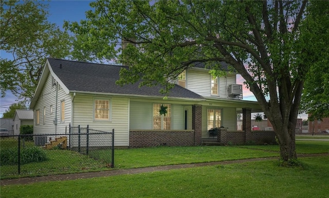view of front of home featuring central AC unit, a front lawn, fence, and covered porch