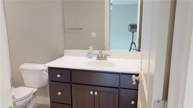 3006 E Stillwater Lndg, Urbana, IL 61802 - half bathroom with vanity, toilet, and a ceiling fan