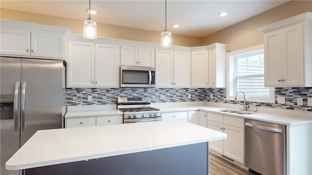 3006 E Stillwater Lndg, Urbana, IL 61802 - kitchen featuring appliances with stainless steel finishes, a sink, white cabinets, a center island, and decorative backsplash