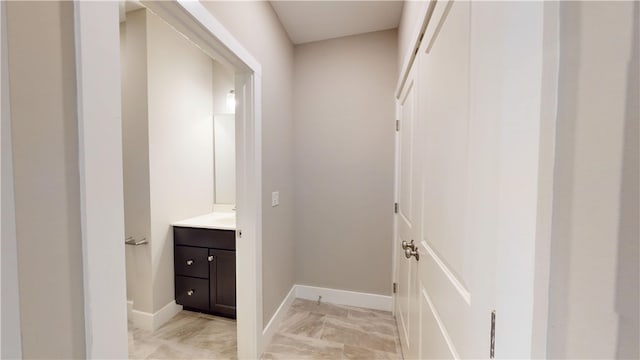 3006 E Stillwater Lndg, Urbana, IL 61802 - bathroom with vanity, marble look tiles, and baseboards