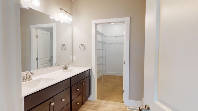 3006 E Stillwater Lndg, Urbana, IL 61802 - full bathroom featuring double vanity, a walk in closet, and baseboards