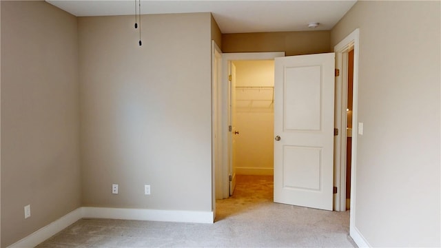 3006 E Stillwater Lndg, Urbana, IL 61802 - unfurnished bedroom featuring carpet floors, a walk in closet, baseboards, and a closet