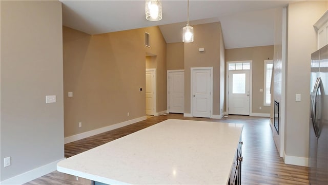 3006 E Stillwater Lndg, Urbana, IL 61802 - kitchen with freestanding refrigerator, pendant lighting, light wood finished floors, baseboards, and high vaulted ceiling