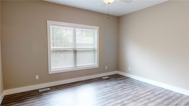 3006 E Stillwater Lndg, Urbana, IL 61802 - spare room with ceiling fan, wood finished floors, and baseboards