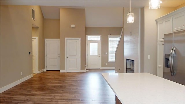 3006 E Stillwater Lndg, Urbana, IL 61802 - kitchen featuring stainless steel fridge, wood finished floors, baseboards, white cabinetry, and light countertops