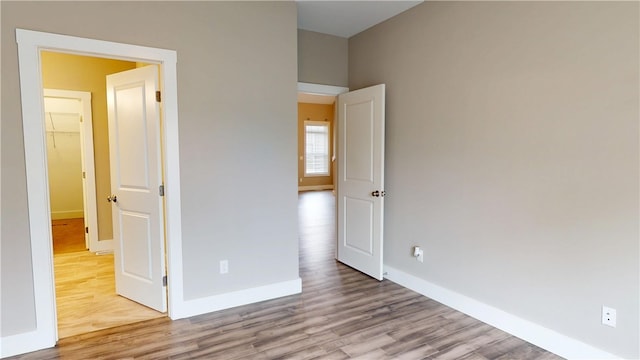 3006 E Stillwater Lndg, Urbana, IL 61802 - unfurnished bedroom with wood finished floors and baseboards