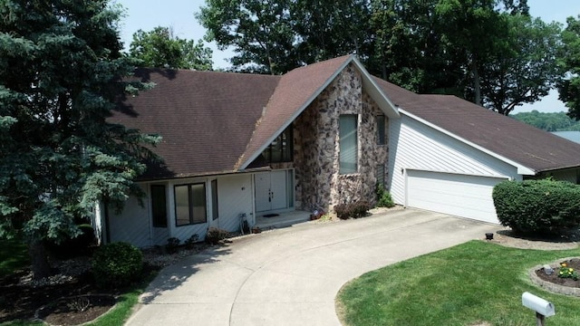 10 Lakeshore Ct, Danville, IL 61832 - view of front facade featuring a garage, concrete driveway, stone siding, and a shingled roof