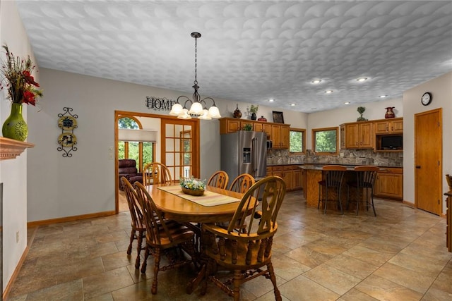 8434 Meadowview Rd, Effingham, IL 62401 - dining space with a chandelier, stone tile floors, recessed lighting, and a fireplace