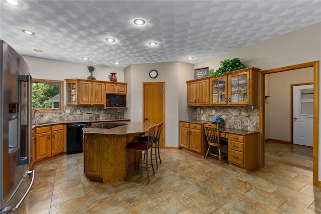 8434 Meadowview Rd, Effingham, IL 62401 - kitchen with black appliances, brown cabinetry, a kitchen island, decorative backsplash, and recessed lighting