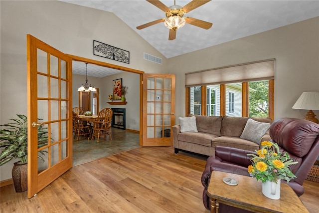 8434 Meadowview Rd, Effingham, IL 62401 - living room with french doors, a chandelier, light wood-style flooring, ceiling fan, and high vaulted ceiling