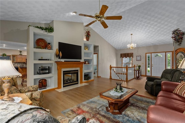 8434 Meadowview Rd, Effingham, IL 62401 - living room with lofted ceiling, wood finished floors, ceiling fan, a chandelier, and built in shelves