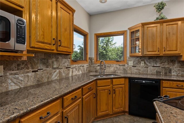 8434 Meadowview Rd, Effingham, IL 62401 - kitchen with stainless steel microwave, black dishwasher, and brown cabinetry