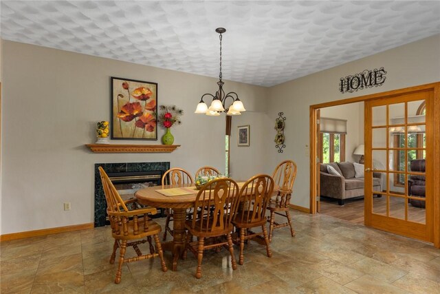 8434 Meadowview Rd, Effingham, IL 62401 - dining room featuring a fireplace, a chandelier, and stone tile flooring