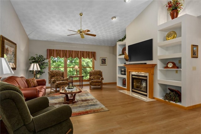 8434 Meadowview Rd, Effingham, IL 62401 - living room featuring ceiling fan, a fireplace with flush hearth, built in features, lofted ceiling, and wood finished floors