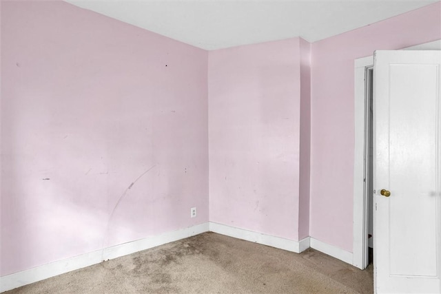 empty room with carpet floors and baseboards