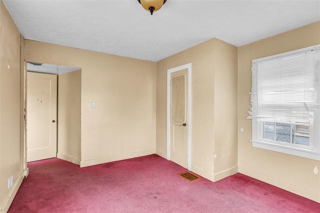 unfurnished bedroom with baseboards, visible vents, and carpet flooring