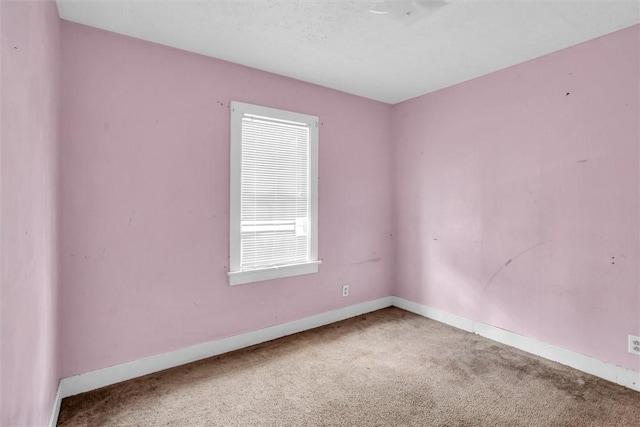 empty room with carpet floors and baseboards