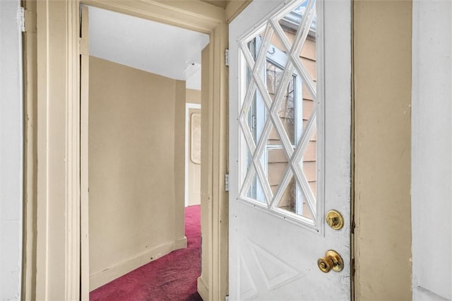 interior space featuring baseboards, carpet floors, and a healthy amount of sunlight