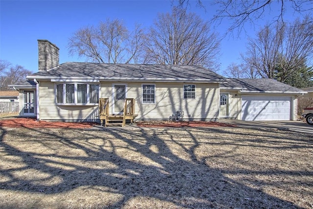 ranch-style house featuring an attached garage and a chimney