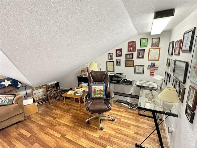 1113 Unique Ct, Mattoon, IL 61938 - office space featuring a textured ceiling, vaulted ceiling, light wood-style floors, and a textured wall