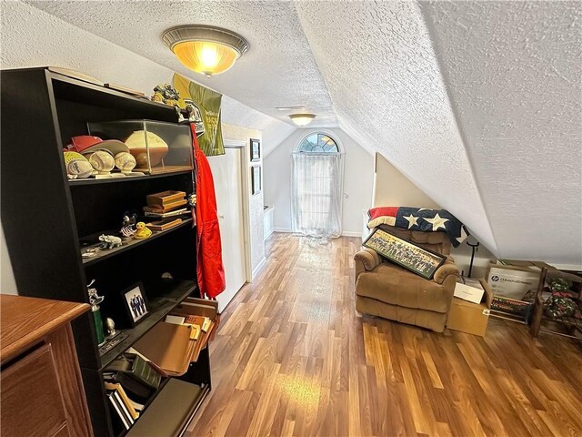 1113 Unique Ct, Mattoon, IL 61938 - additional living space featuring a textured ceiling, wood finished floors, lofted ceiling, and baseboards