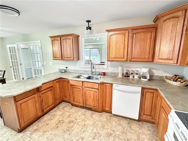 1113 Unique Ct, Mattoon, IL 61938 - kitchen with white appliances, a sink, a peninsula, brown cabinets, and light countertops
