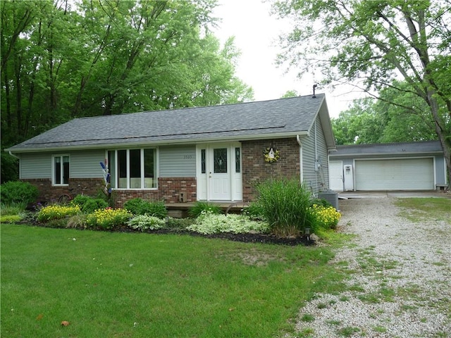 3535 Ferndale Ave, Danville, IL 61834 - ranch-style home with brick siding, a shingled roof, a front lawn, central AC unit, and a detached garage