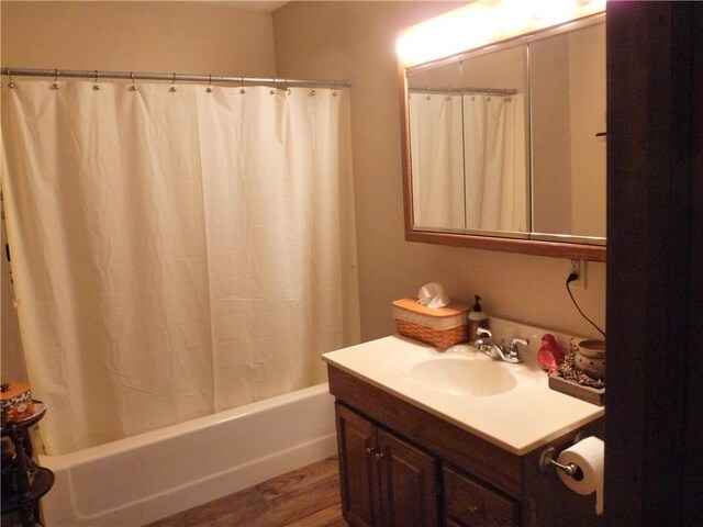 3535 Ferndale Ave, Danville, IL 61834 - full bath with wood finished floors, vanity, and shower / bath combo with shower curtain