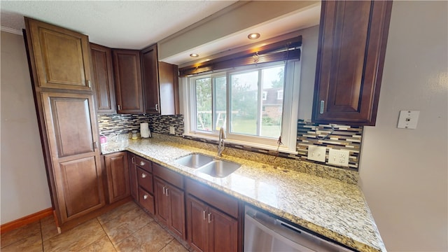 204 Bryan St, Catlin, IL 61817 - kitchen featuring a sink, tasteful backsplash, light stone countertops, stainless steel dishwasher, and baseboards