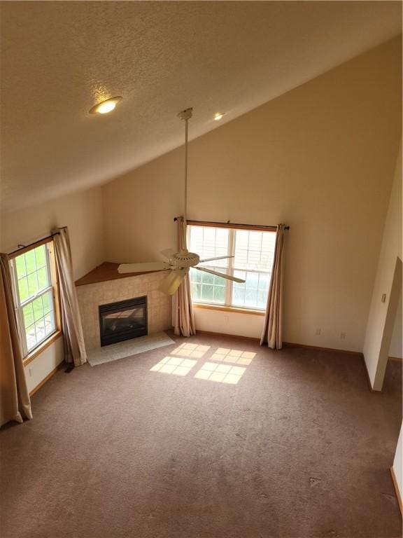 107 Edgewood Ave, Effingham, IL 62401 - unfurnished living room with lofted ceiling, carpet floors, and a tiled fireplace