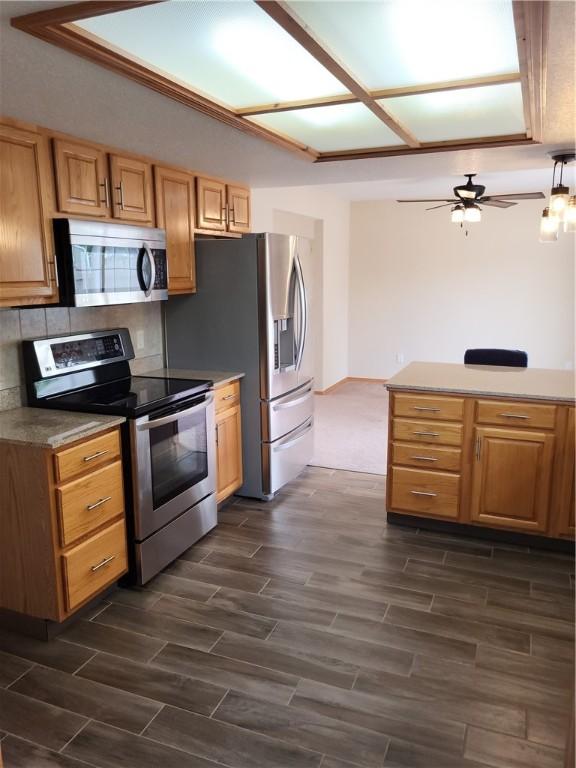 107 Edgewood Ave, Effingham, IL 62401 - kitchen with stainless steel appliances, dark wood-style flooring, ceiling fan, and tasteful backsplash
