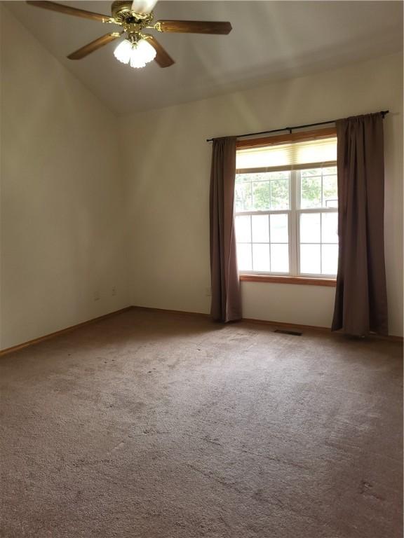 107 Edgewood Ave, Effingham, IL 62401 - unfurnished room with lofted ceiling, light carpet, and ceiling fan