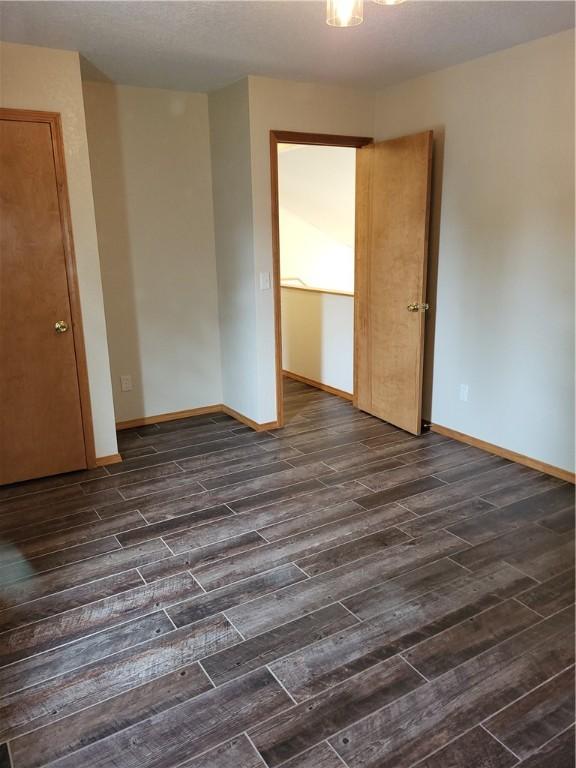 107 Edgewood Ave, Effingham, IL 62401 - empty room with dark wood-style flooring and baseboards