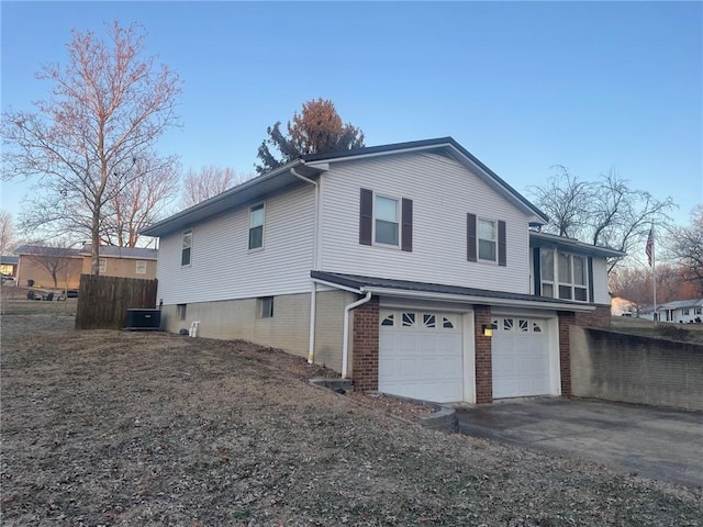 view of home's exterior featuring a garage and cooling unit