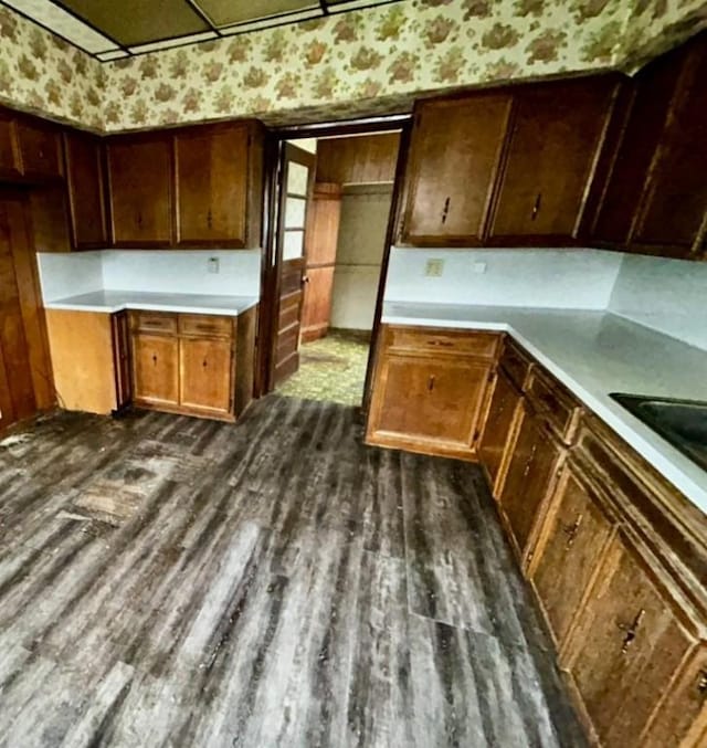 316 Plum St, Danville, IL 61832 - kitchen with dark wood-type flooring, light countertops, and wallpapered walls