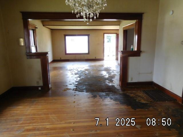 316 Plum St, Danville, IL 61832 - unfurnished dining area with wood finished floors and a chandelier