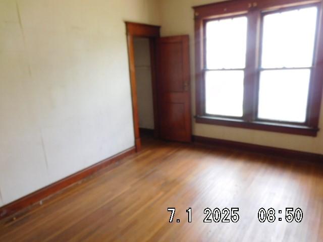 316 Plum St, Danville, IL 61832 - empty room with wood finished floors and healthy amount of natural light