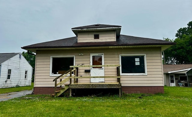 316 Plum St, Danville, IL 61832 - back of house featuring a yard and roof with shingles