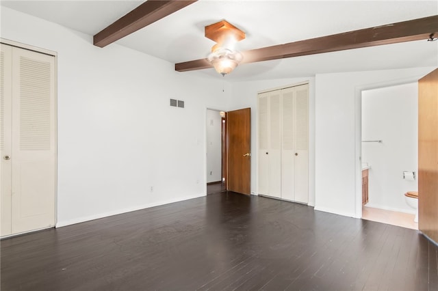3044 Greenlake Dr, Decatur, IL 62521 - unfurnished bedroom featuring beam ceiling, dark wood-style flooring, ensuite bath, and ceiling fan