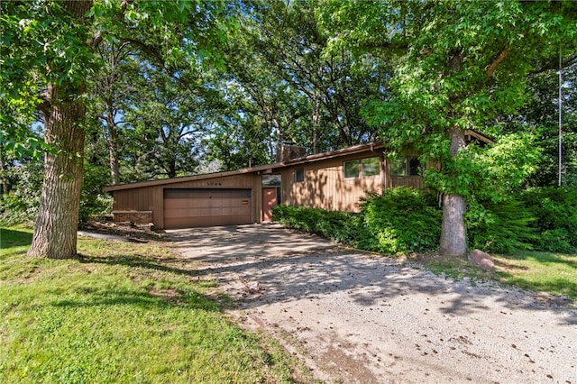 3044 Greenlake Dr, Decatur, IL 62521 - mid-century inspired home featuring driveway, an attached garage, and a chimney