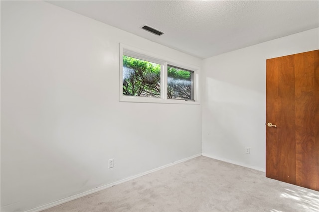 3044 Greenlake Dr, Decatur, IL 62521 - spare room with light colored carpet and a textured ceiling