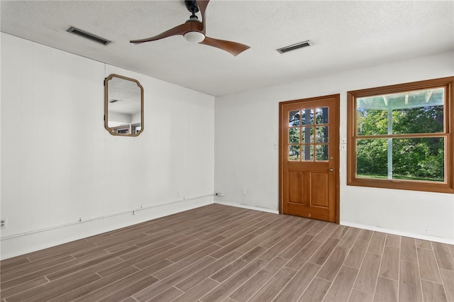 3044 Greenlake Dr, Decatur, IL 62521 - empty room with a textured ceiling, wood finished floors, and a ceiling fan